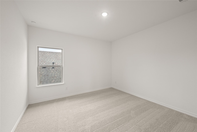 carpeted spare room with baseboards