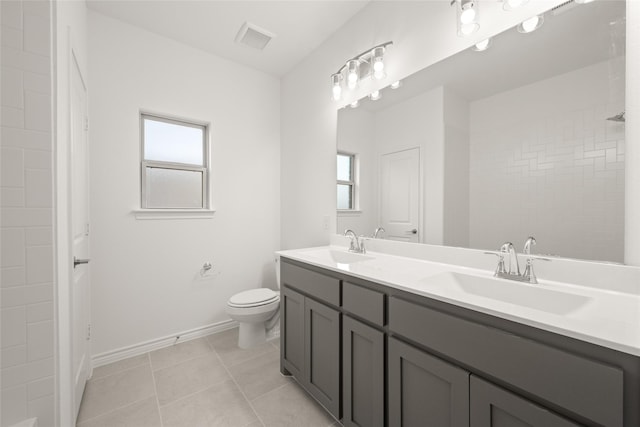 full bathroom featuring visible vents, toilet, double vanity, tile patterned floors, and a sink