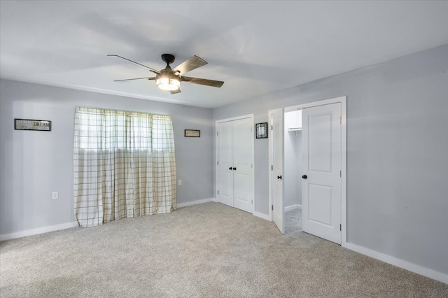 carpeted spare room with ceiling fan