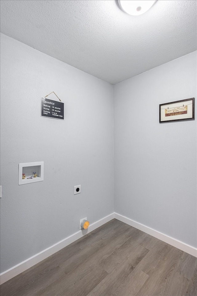 laundry room with dark hardwood / wood-style flooring, washer hookup, a textured ceiling, and hookup for an electric dryer