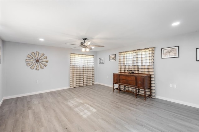 unfurnished room with ceiling fan and light hardwood / wood-style flooring