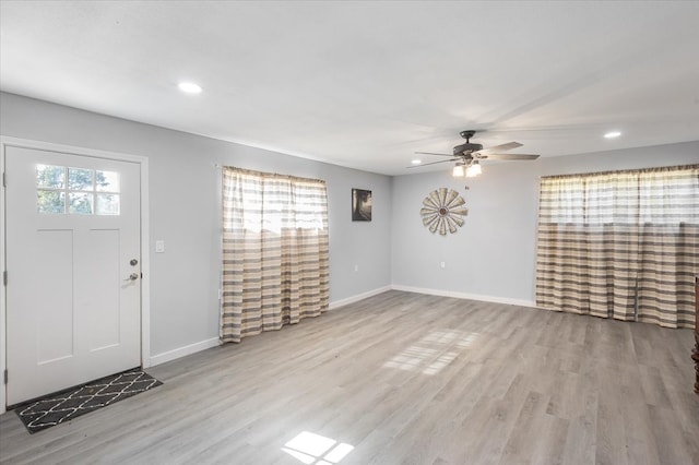 entryway with ceiling fan and light hardwood / wood-style floors