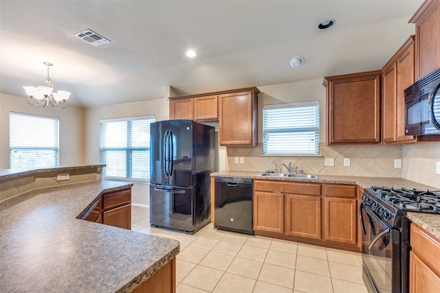 kitchen featuring black appliances, sink, hanging light fixtures, tasteful backsplash, and a notable chandelier