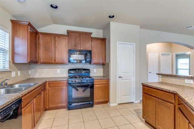 kitchen featuring sink, tasteful backsplash, a wealth of natural light, and black appliances