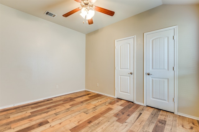 unfurnished bedroom with ceiling fan, light hardwood / wood-style floors, and vaulted ceiling