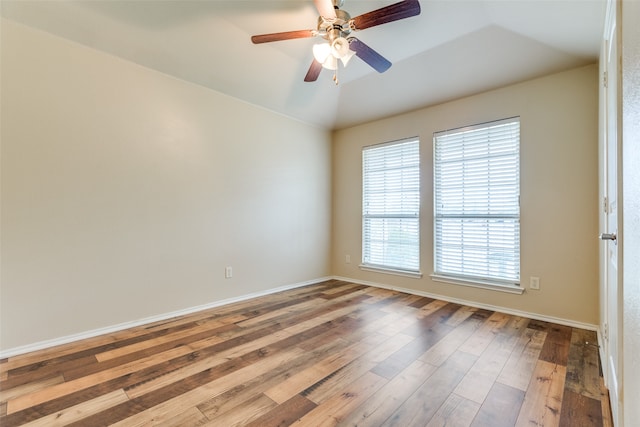 unfurnished room featuring hardwood / wood-style flooring, vaulted ceiling, and ceiling fan