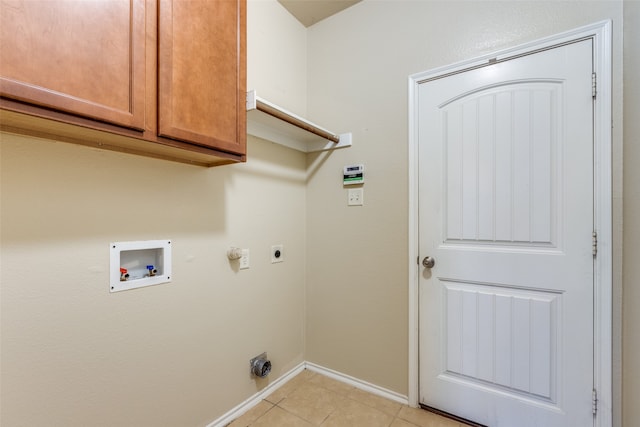 washroom featuring washer hookup, light tile patterned floors, cabinets, and hookup for an electric dryer