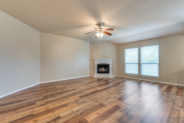 unfurnished living room with ceiling fan and hardwood / wood-style floors