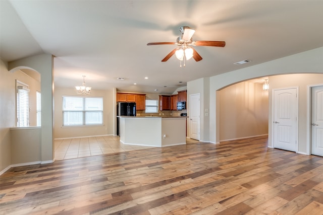 kitchen with ceiling fan with notable chandelier, light wood-type flooring, and black appliances