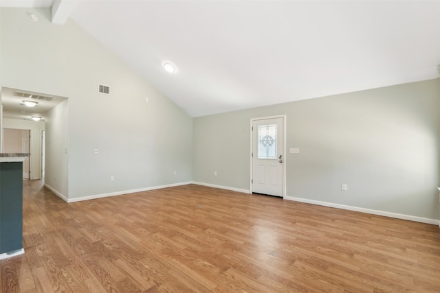 foyer entrance with beam ceiling, light wood-type flooring, and high vaulted ceiling