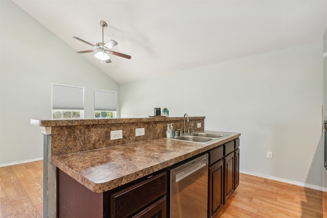 kitchen featuring sink, an island with sink, stainless steel dishwasher, and light hardwood / wood-style flooring