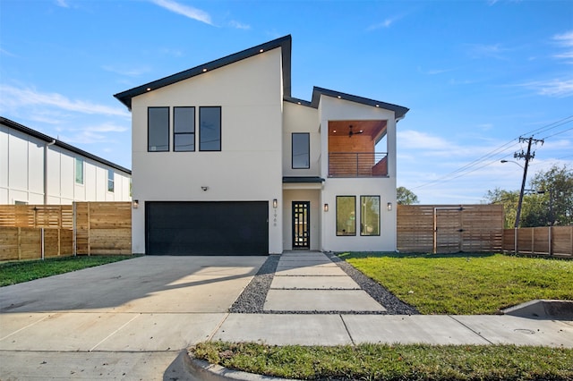 contemporary home with a garage, a front lawn, and a balcony