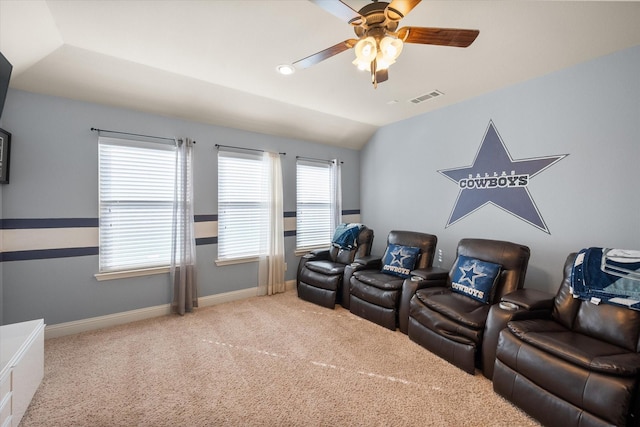 cinema room featuring vaulted ceiling, baseboards, carpet floors, ceiling fan, and visible vents