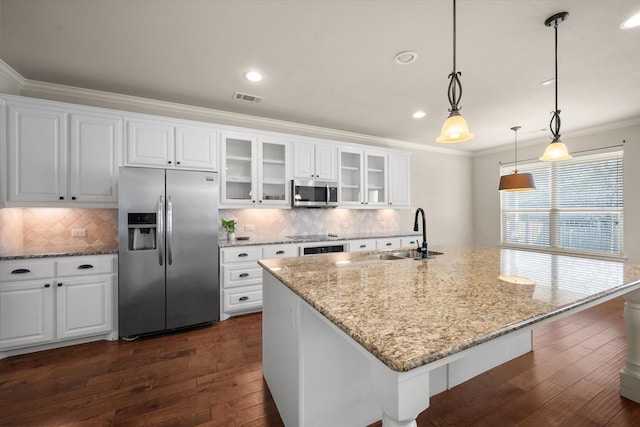 kitchen with a sink, ornamental molding, visible vents, and appliances with stainless steel finishes