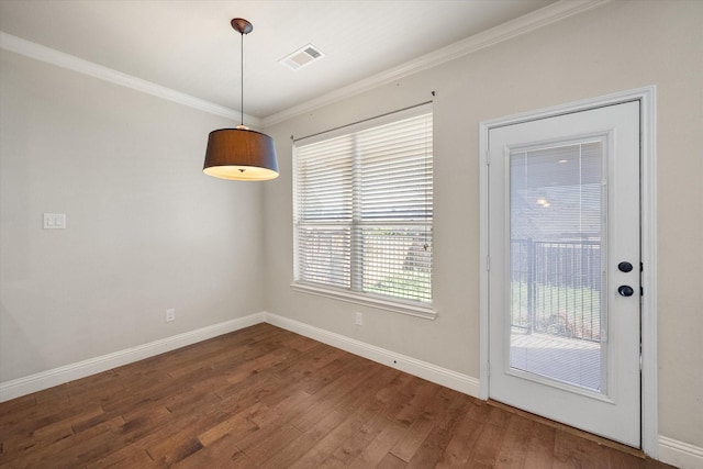 unfurnished dining area with visible vents, crown molding, and wood finished floors