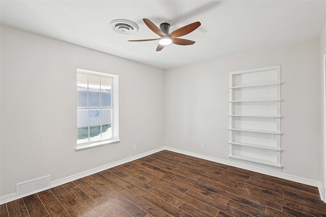 spare room featuring ceiling fan and dark hardwood / wood-style floors