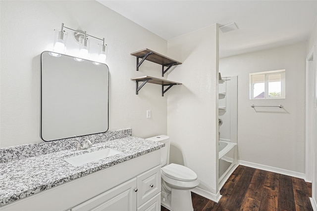 full bathroom with washtub / shower combination, toilet, wood-type flooring, and vanity