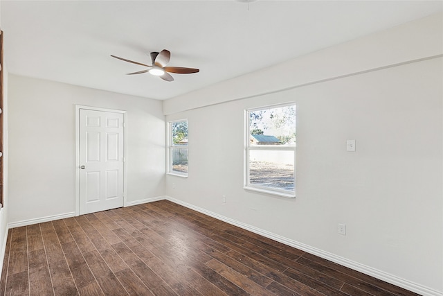 empty room featuring ceiling fan and dark wood-type flooring