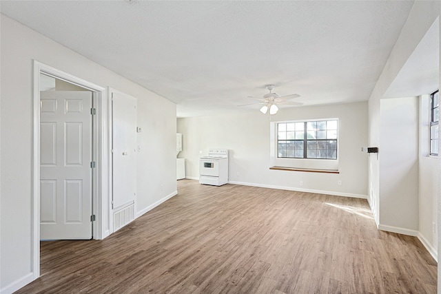 unfurnished living room with ceiling fan and light wood-type flooring