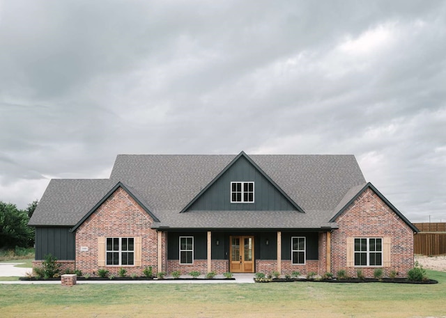 craftsman house featuring a front yard and french doors