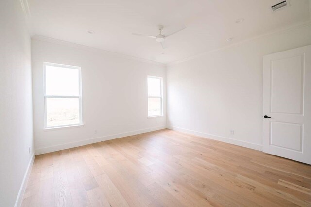 unfurnished room featuring ceiling fan, plenty of natural light, ornamental molding, and light wood-type flooring