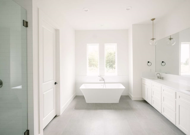 bathroom with tile patterned floors, vanity, and independent shower and bath