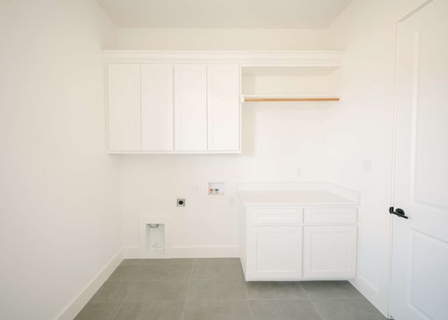 laundry area with cabinets, hookup for a washing machine, light tile patterned floors, and electric dryer hookup