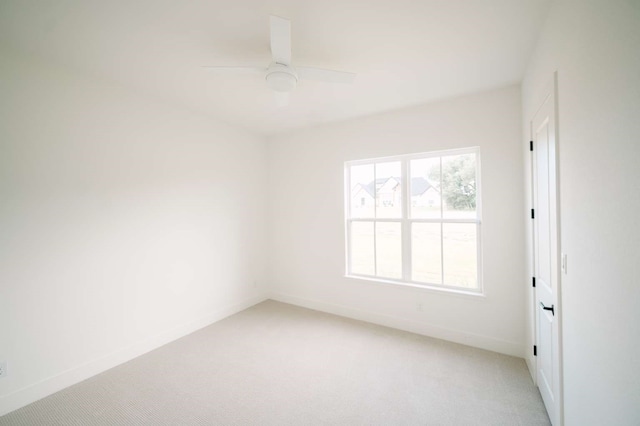 spare room with ceiling fan and carpet