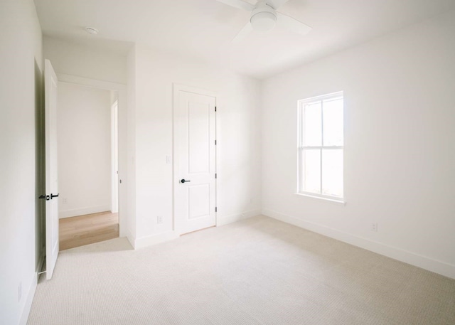 unfurnished bedroom featuring light carpet and ceiling fan