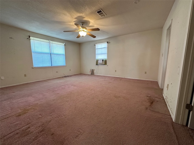 interior space featuring carpet flooring, a textured ceiling, ceiling fan, and cooling unit