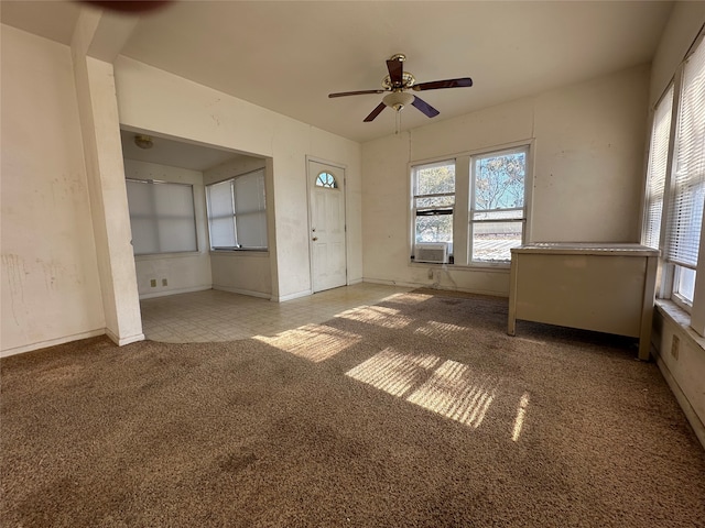 unfurnished living room featuring light carpet and ceiling fan