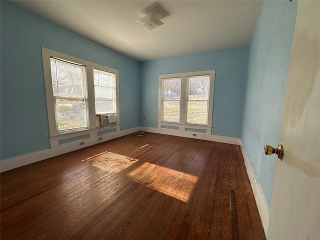 unfurnished room featuring cooling unit and wood-type flooring