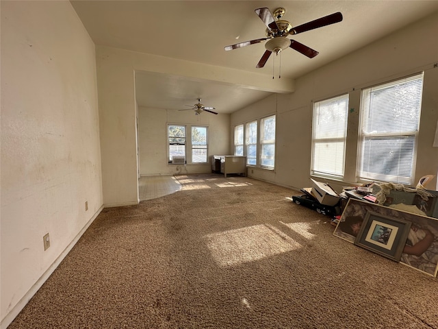 miscellaneous room featuring carpet, ceiling fan, and beamed ceiling