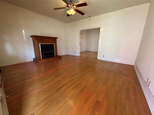 unfurnished living room with ceiling fan and hardwood / wood-style floors