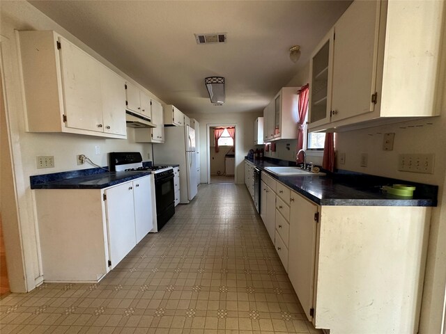 kitchen with sink, white cabinets, and white appliances