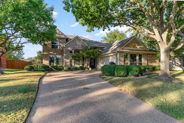 view of front of property with a front yard and a garage