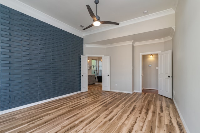 interior space with ceiling fan, crown molding, brick wall, and light wood-type flooring