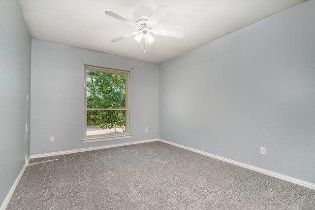 carpeted spare room featuring ceiling fan