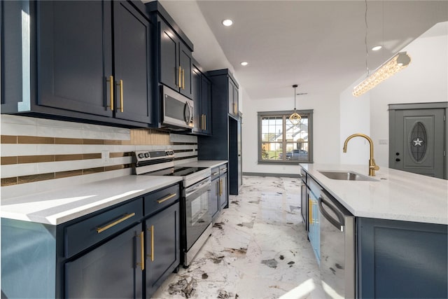 kitchen featuring decorative backsplash, appliances with stainless steel finishes, a kitchen island with sink, sink, and pendant lighting