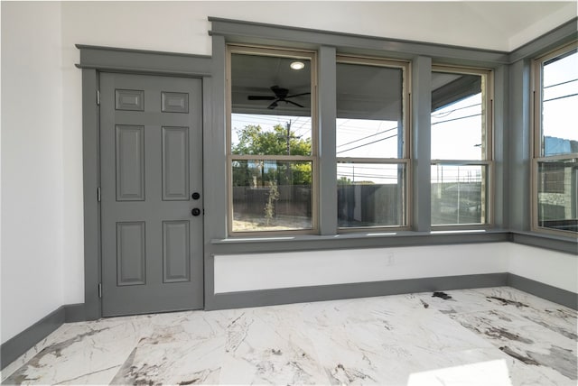 entrance to property with ceiling fan