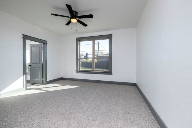 carpeted empty room featuring ceiling fan