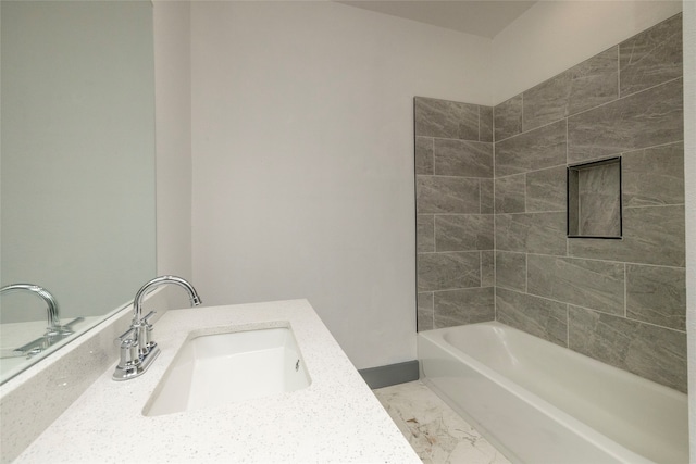 bathroom with vanity and tiled shower / bath combo