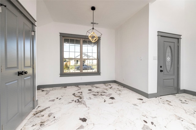 unfurnished dining area featuring lofted ceiling