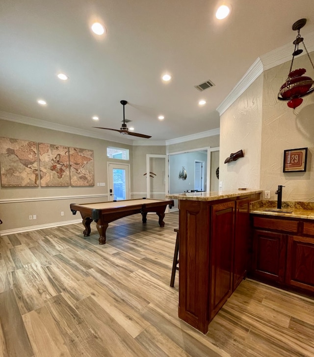 playroom featuring ceiling fan, light hardwood / wood-style floors, and ornamental molding