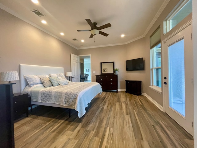 bedroom with ceiling fan, hardwood / wood-style floors, and crown molding