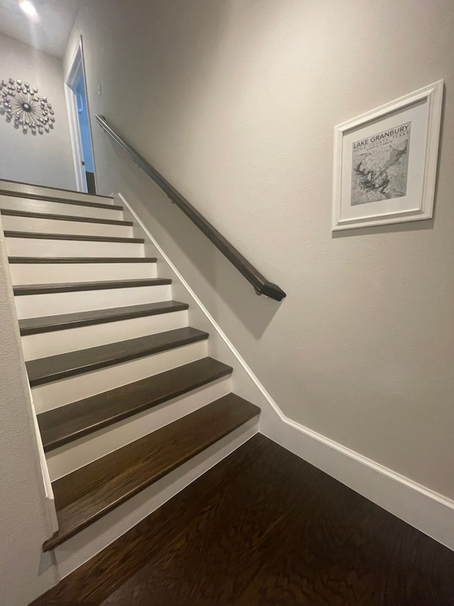 staircase featuring hardwood / wood-style floors