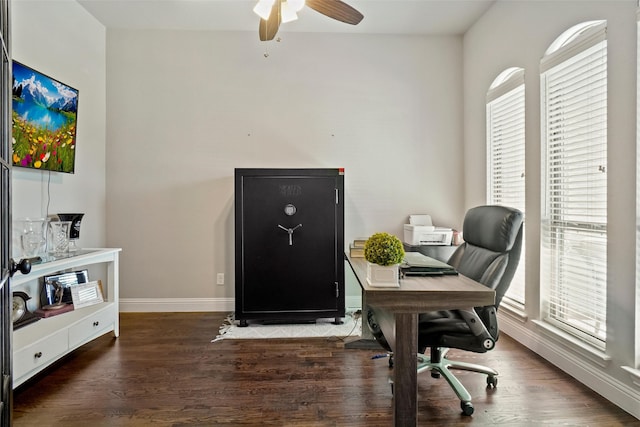 office with a wealth of natural light, dark wood-type flooring, and ceiling fan