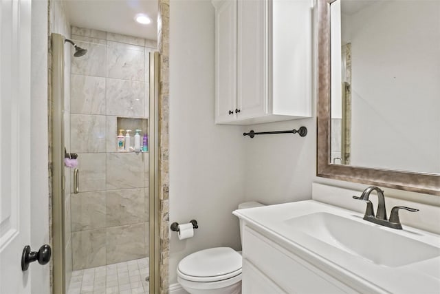 bathroom featuring vanity, toilet, and walk in shower