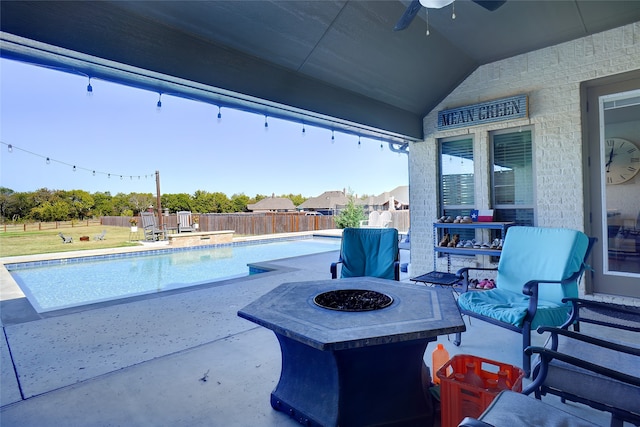 view of pool with an outdoor fire pit and a patio