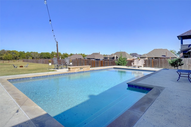 view of pool featuring a patio area and a yard